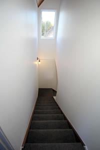 a staircase in a small room with a window at Central Studio in Auckland