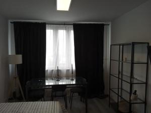 a bedroom with a desk in front of a window at Alexanderplatz Fresh Adorable Studio in Berlin