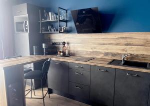 a kitchen with a sink and a counter top at NUITS D'EXIL in Gérardmer