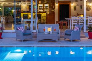 a pool with chairs and a table and a restaurant at HOTEL DALYANCE in Dalyan