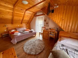 a room with two beds in a wooden cabin at Guesthouse Green Valley in Plitvička Jezera