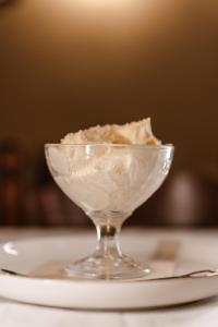 a glass bowl of ice cream on a plate at Tamahuche Hotel Rural in Vallehermoso