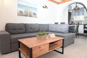 a living room with a couch and a coffee table at Seaward in Kamari