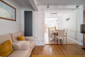 a living room with a white couch and a table at Coxswains House 4 in Wells next the Sea