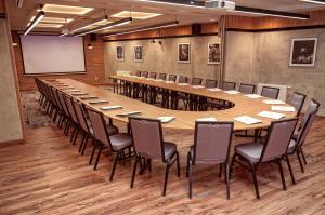a large conference room with a long table and chairs at Hotel Wieniawski in Lublin