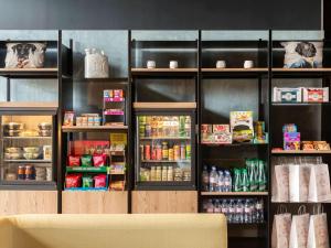 a store with a refrigerator filled with food and drinks at Aparthotel Adagio access Palaiseau Saclay in Palaiseau