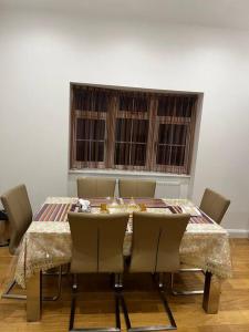 a dining room with a table with chairs and a window at The Forest Haven Cottage - Free Parking & Wi-Fi in Whitefield