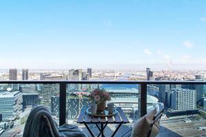 a living room with a view of a city at A Modern 2BR Apt with Harbour Views FREE Parking in Melbourne