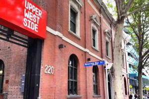 a red brick building with a sign on it at A Modern 2BR Apt with Harbour Views FREE Parking in Melbourne