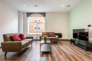 a living room with two couches and a tv at Characterful 2 Bed Apartment with Parking in Central Hull in Hull