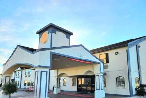 a building with a clock tower on top of it at Days Inn by Wyndham Rosenberg in Rosenberg