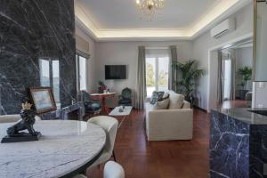 a living room with a table and a couch at Pafsilipon Suites in Ermoupoli