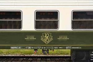 a green and white train car on the tracks at Canfranc Estación, a Royal Hideaway Hotel - Gran Lujo in Canfranc-Estación