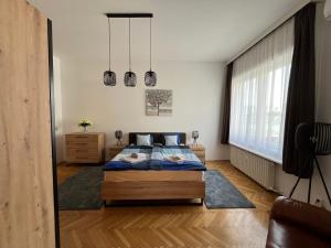 a bedroom with a bed and a large window at Apartamento Ecléctico Budapest in Budapest