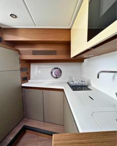 a kitchen with white counters and a sink at Boat For Events in Naples