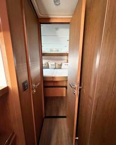 an open door to a small room with a bed at Boat For Events in Naples
