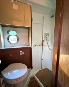 a small bathroom with a toilet and a shower at Boat For Events in Naples