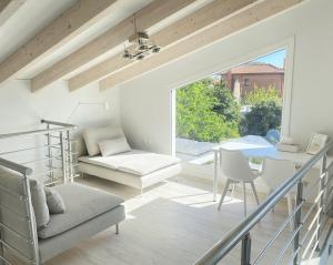 a living room with a staircase and a chair at A Homes Greece Athens - Luxurious Beach Villa with Private Garden in Nea Makri +25 photos