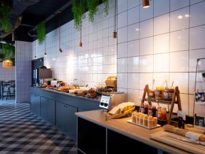 a kitchen with a counter with food on it at ibis Styles Strasbourg Nord Palais des Congrès in Schiltigheim