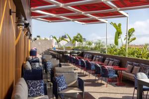 a row of chairs and tables on a rooftop patio at Doubletree By Hilton Lima San Isidro in Lima