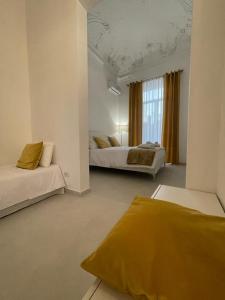 una grande camera con due letti e una finestra di Cutelli Gold a Catania
