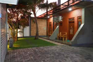 a house with a palm tree in front of it at Airport Colombo Pocket Paradise in Seeduwa