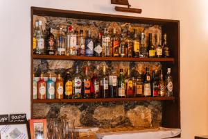 a bunch of bottles of alcohol on a wall at Tamahuche Hotel Rural in Vallehermoso