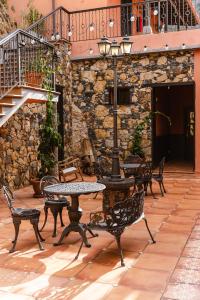 a patio with tables and chairs and a street light at Tamahuche Hotel Rural in Vallehermoso