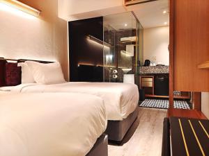 Postel nebo postele na pokoji v ubytování Bintang Collectionz Hotel