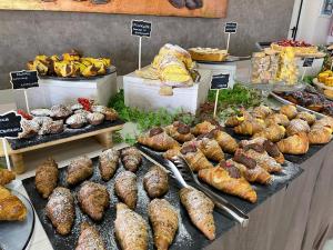 a bakery with many different types of bread and pastries at Hotel Tyc Soleti Hotels in Rimini