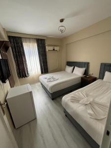 a hotel room with two beds and a window at Hotel Wiva in Istanbul