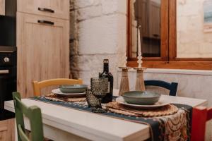 a table with two bowls and a bottle of wine at Casa Sea La Vie in Ostuni