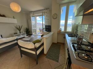 a kitchen and living room with a view of the city at Miralago in Stresa
