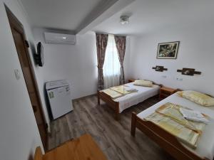 Postel nebo postele na pokoji v ubytování Sándor Panzió