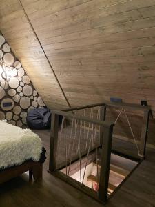 a room with a wooden ceiling with a cage at SweeDom Shale in Almaty