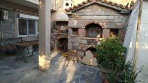 un horno de piedra en un patio con mesa en Stone home Lyhna, en Líkhna