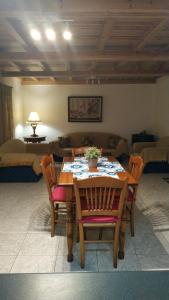 a dining room with a table and chairs and a couch at Stone home Lyhna in Líkhna