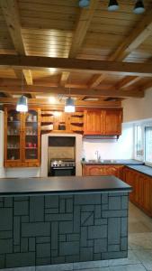 a large kitchen with wooden cabinets and a counter top at Stone home Lyhna in Líkhna