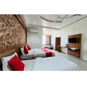 a hotel room with two beds and a couch at hotel hill city in Gandhinagar