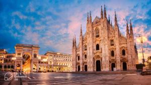 a large cathedral in a city at night at Apartment Navigli Milano in Milan