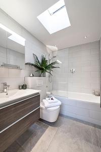 a bathroom with a toilet and a tub and a sink at Kensington Oasis Central London 2BR Private House - Near Harrods, Kensington Palace, and other London Attractions in London