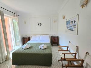 a bedroom with a bed with two towels on it at Capri Lovers in Capri