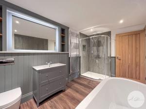 a large bathroom with a tub and a shower at Exceptional Holiday Home 5 with Hot Tub Pickering in Pickering