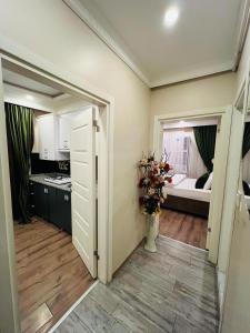 a room with a kitchen and a vase of flowers at Bona apart in Istanbul +27 photos