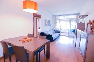 a kitchen and living room with a table and a dining room at Touch the Sky in Hospitalet de Llobregat