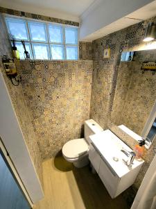 uma casa de banho com um WC e um lavatório em The Sun House em Santa Iria de Azóia