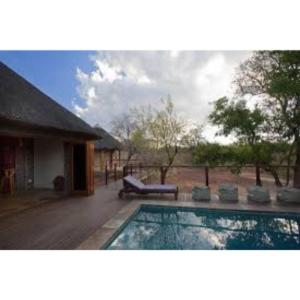 - une piscine en face d'une maison dans l'établissement Mount Marula Game Lodge - Tambotie, à Kwarriekraal