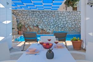 a table with two glasses of wine on a patio at Villa Sheyma in Kalkan