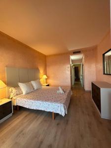 a bedroom with a bed and a dresser and a television at Piso islas C111 in Benalmádena +33 photos