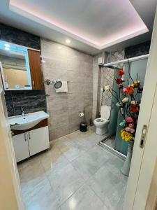 a bathroom with a toilet and a sink at Bona apart in Istanbul +28 photos